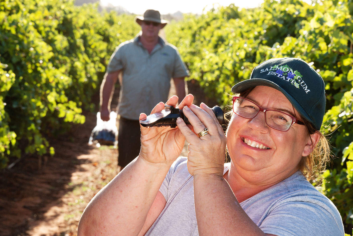 Jacque Schulz testing the quality of their riverland vineyard grapes